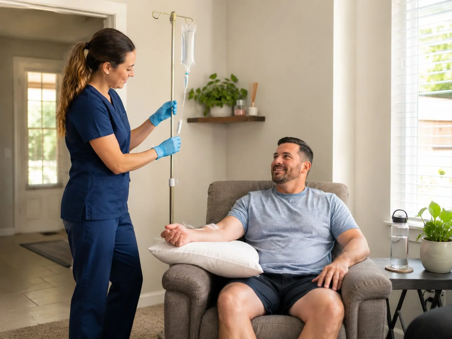 Nurse starting an IV hydration drip for a relaxed patient at home in Phoenix, Arizona